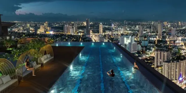 Sky Deck Pool at One Delta Terraces at night with the Metro Manila skyline, DMCI Homes condo amenity in Quezon City